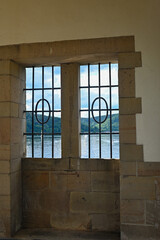 View through a barred window at the Staudam on the Eder lake