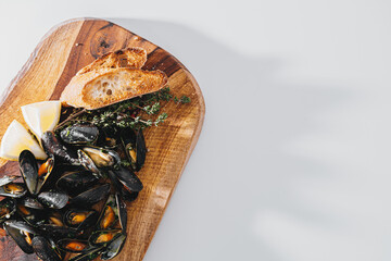boiled mussels with parsley, spinach, Asian herbs and lemon and toasted baguette