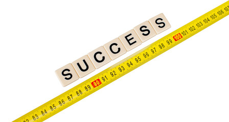Yellow measuring tape with word success isolated on white background