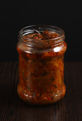 Imam bayaldy - Appetizer of eggplant stuffed with tomatoes, onion and garlic stewed in vegetable oil. Appetizer of canned fried eggplant in a glass container