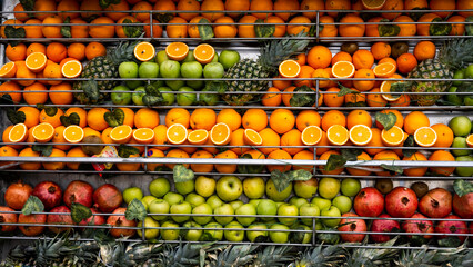 Fruits lined up on the shelves, Orange, Pineapple, Pomegranate, Apple, Mango, Tangerine