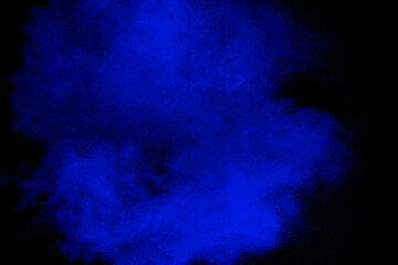 Fototapeta na wymiar Blue powder explosion cloud on black background.Launched blue dust particle splash.