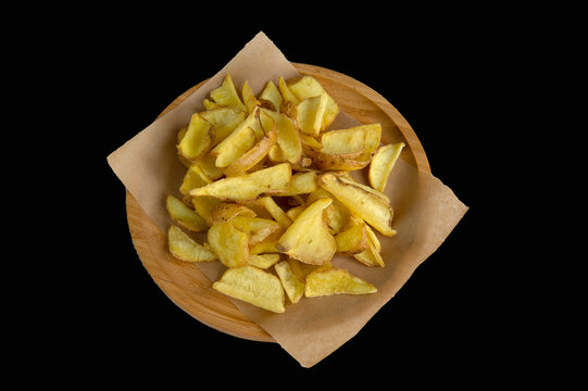 Italian fried dippers potatoes in wooden dish on black background