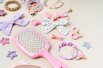 Set of baby girl hair accessories. Fashion hair bows, hair brush, hair clips, hairpins and hair elastics.  Hairstyles for girls with stylish accessory.