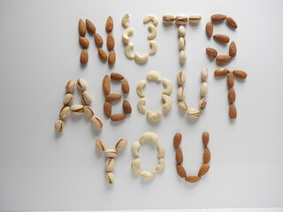 Amusing valentines love message nuts about you written in almonds, pistachios and cashew nuts on white background