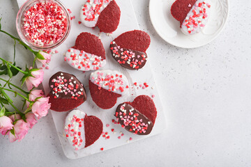 Obraz na płótnie Canvas Valentines Day. Red velvet or brownie cookies on heart shaped in chocolate icing on a pink romantic background. Dessert idea for Valentines Day, Mothers or Womens Day. Tasty homemade cake for holiday