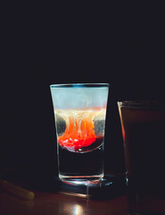 Refreshing hot summer alcoholic shot with flame drop