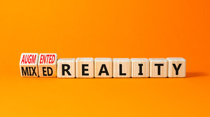Augmented or mixed reality symbol. Concept words Augmented reality Mixed reality on wooden cubes. Beautiful orange table orange background. Business augmented or mixed reality concept. Copy space.