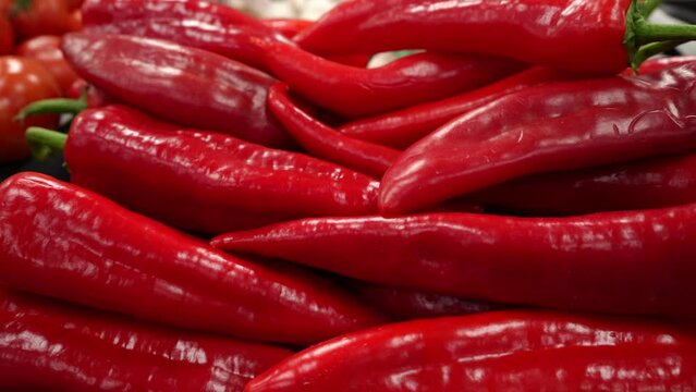 Pods of red hot chili peppers. Red peppers on the counter of a farm shop. Close-up. High quality 4k footage