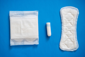 Health care and medicine tampons, pads on blue background
