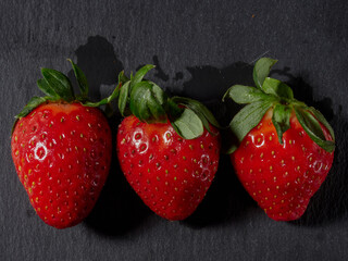 strawberries isolated on black background