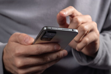Close up of a man using mobile smart phone