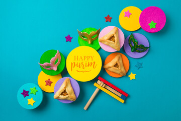 Purim creative background with carnival mask and traditional cookies on colorful podiums. Top view, flat lay