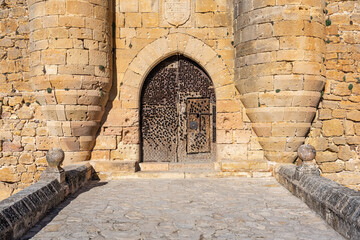 Entrance to the medieval castle of Pedraza with its defensive gate full of iron spikes to defend...