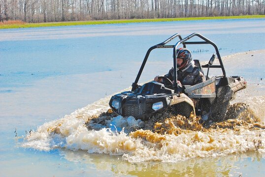 A four-wheeler in a flooded rice field