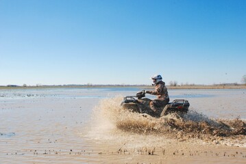 Obraz na płótnie Canvas An ATV in a muddy field 