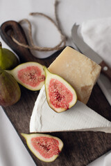 cheese and figs on a wooden board