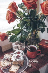 still life valentine's day red flowers, cup and cake on the window
