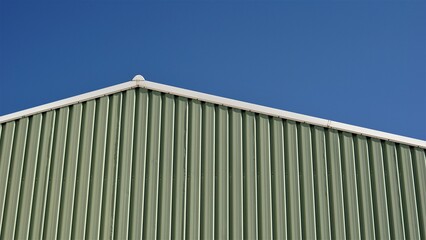 roof of industrial warehouse building against the sky