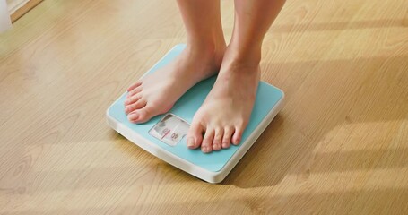 woman measure weight on scale - Powered by Adobe