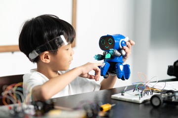 young boy having fun connecting electronic circuit board