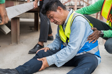 Asian male worker accident at his leg at construction site. Industrial accident concept