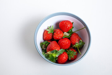 red strawberry with water in bowl