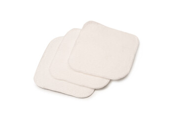Stack of white cotton sponges isolated on a white background.