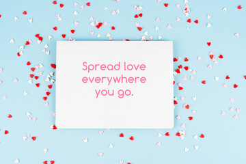 Paper note and confetti with inspirational quotes text - Spread love everywhere you go