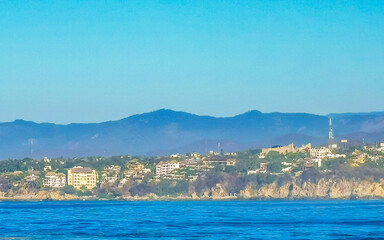Fototapeta premium Beach sand blue water huge surfer waves Puerto Escondido Mexico.