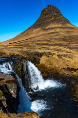 Fototapeta na wymiar Famous Kirkjufell unique shaped Kirkjufell mountain and beautiful waterfall during spring season. Snæfellsnes peninsula, Iceland