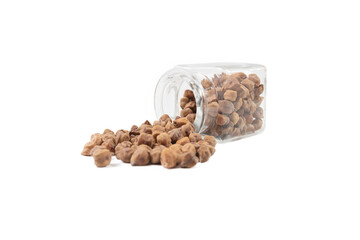 brown chickpeas falling out of the glass jar isolated on white background. nutrition. food ingredient.