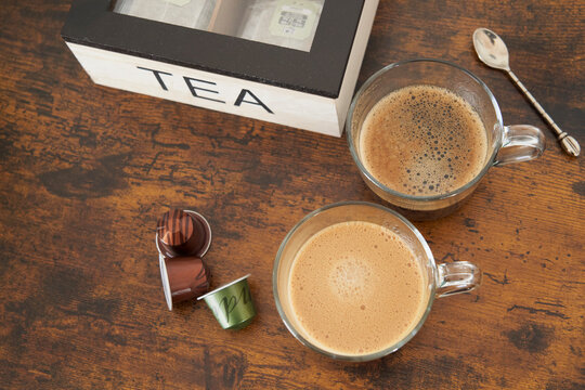 Coffee With Milk And Black Coffee From Capsules On Brown Wooden Table