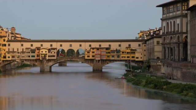 Night to day transition time lapse of Ponte Vecchio, medieval stone bridge over of Arno river in Florence, Italy.