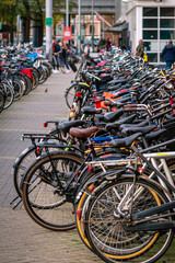Fototapeta na wymiar Bicycles parked in the streets of Amsterdam, the Netherlands. Green and sustainable transport. Alternative transportation.