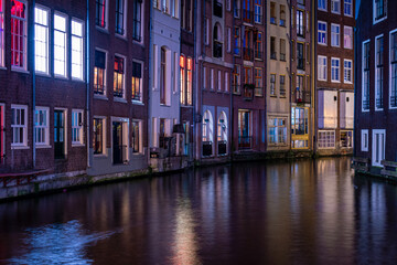 Long exposiure shot of a canal in Amsterdam, the Netherlands. beautiful and colorful lights during the night