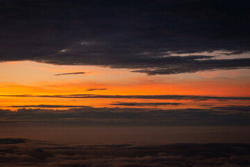 Beautiful sunset above the clouds over the city of Amsterdam, the Netherlands