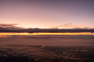 Beautiful sunset above the clouds over the city of Amsterdam, the Netherlands