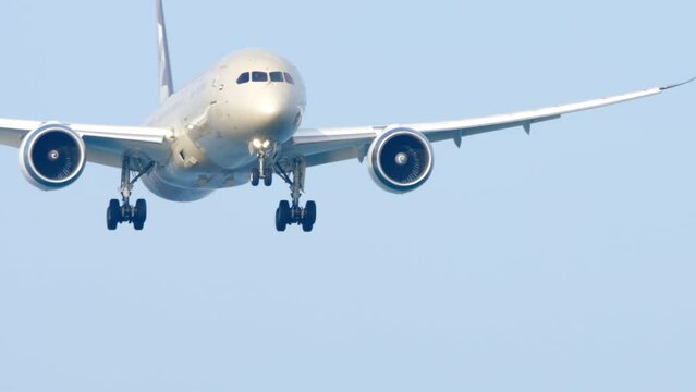 Airliner aapproaches and flies to land. Medium shot footage of a airliner approaching. Passenger flight. Tourism travel concept