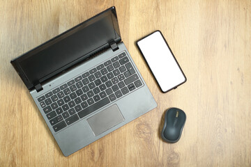 laptop with smartphone and computer mouse on boards - 568144891