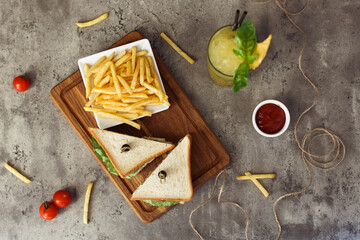 Club sandwich, potato fries chips and glass of drink with ice. Fast food concept. Top view. High quality photo