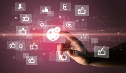 Hand pressing social media multimedia application screen with media icons on futuristic concept