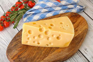 Maasdam cheese piece over board