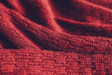 Beautiful knitted texture of red sweater. Close up background.