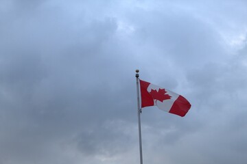 Canadian flag with overcast sky