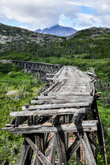 broken wooden bridge in the mountains