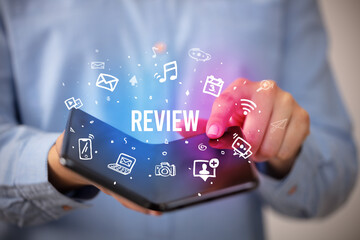 Businessman holding a foldable smartphone, social media concept