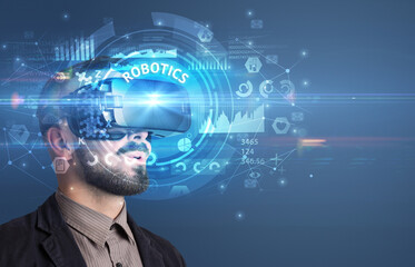 Businessman looking through VR glasses