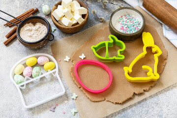 Easter baking ingredients background. Flour, eggs, milk, sugar, butter and kitchen utensils for baking on a stone table.