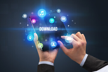 Fototapeta premium Businessman holding a foldable smartphone